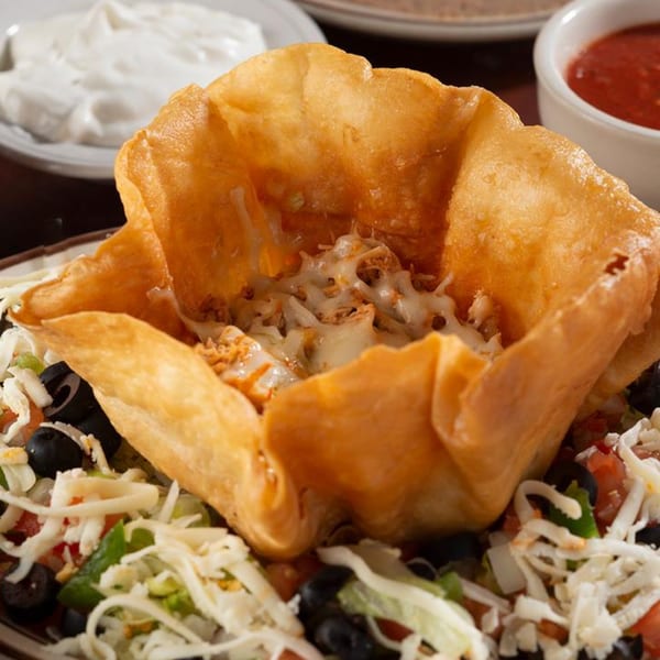 Pancho Villa's Mexican taco salad with a crispy fried shell, shredded cheese, and olives.