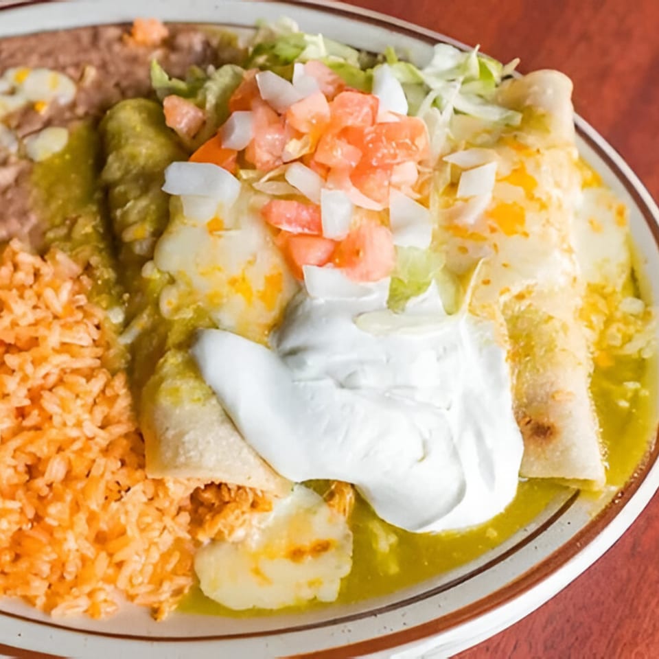 Pancho Villa's enchiladas with green sauce, rice, beans, sour cream, lettuce, and pico de gallo.